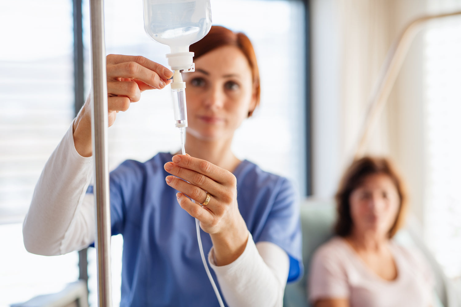 Nurse hanging IV bag